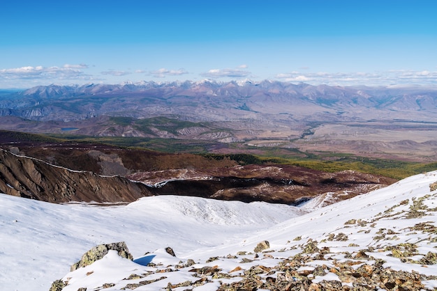 Mountain landscape view from snowy mountain peak Uchitel pass SeveroChuysky ridge Altai Russia