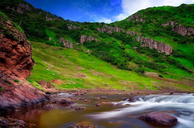 Mountain landscape with lake in summertime Hilly terrain near water with green vegetation Generative AI