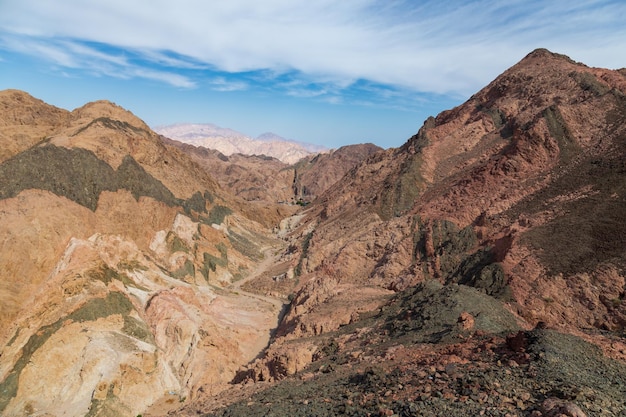 Mountain landscape with layered colorful rock formations in daytime sunlight Dahab Egypt