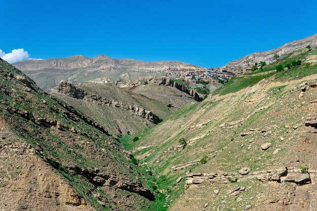 Mountain landscape with rocky cliffs in the distance the mountain village of Chokh in Dagestan