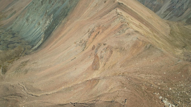 A mountain pass with a steep descent and rocks. Rocky terrain.