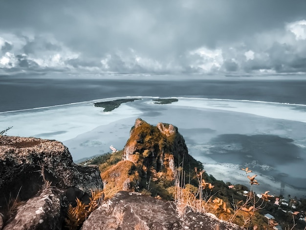 Mountain peak over tropic island blue reef lagoon