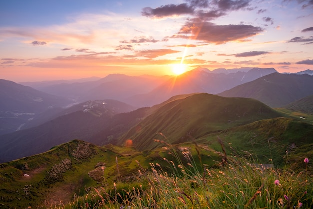 Mountain peaks in sunset light layers of mountains in the haze during sunset