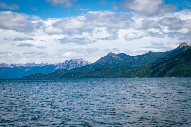 a mountain range with a blue sky and some clouds