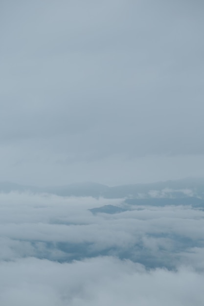 Mountain range with visible silhouettes through the morning blue fog