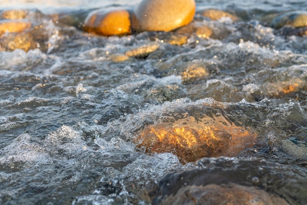 Mountain river flowing fast with splashes over river stones