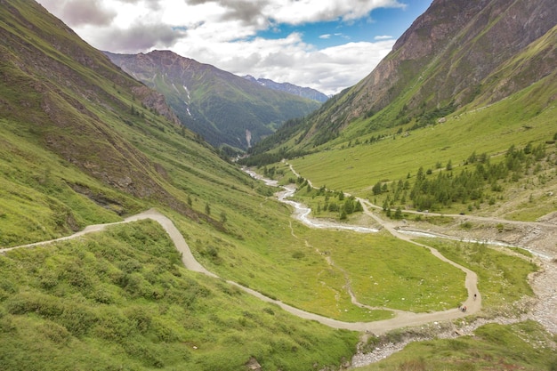 Mountain river tourist route and a green valley between the mountains in Austrian Alps View from the way to Grossglockner rock summit Kals am Grossglockner Austria