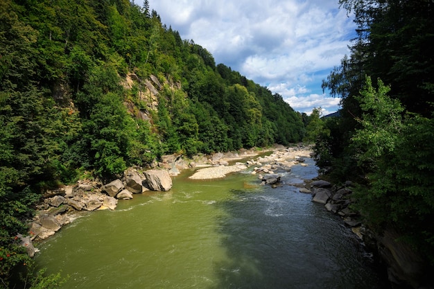 A mountain river with stone banks among mountains