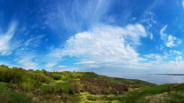 Mountain sea shore in the fall against the blue sky with clouds.