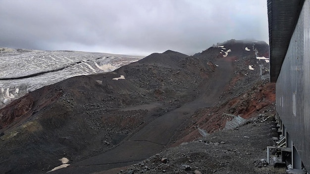 Mountain slopes of the Elbrus region with snow, glaciers and clouds. Elbrus region,