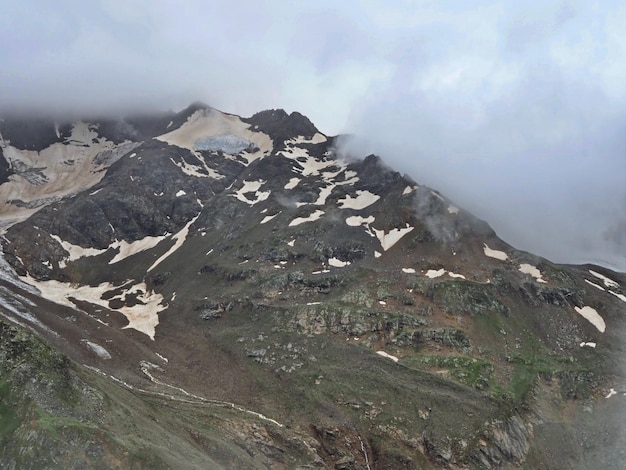 Mountain slopes of the Elbrus region with snow, glaciers and clouds. Elbrus region,