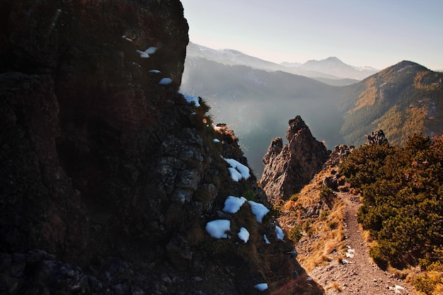 Mountain snowy landscape with rock