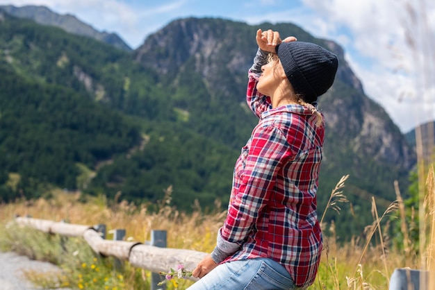 Mountain tourist outdoor leisure activity concept Woman looking the sky Tourism and tourist summer holiday vacation Country side freedom and activity