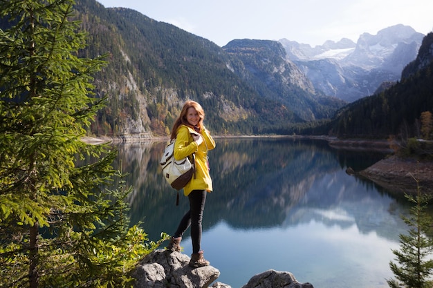 mountain trip happy girl on the background of a mountain lake and mountains in the background