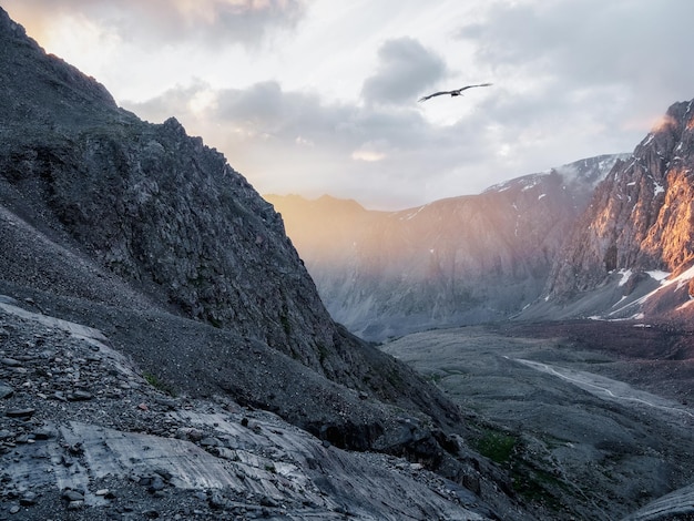 Mountain valley at sunrise Awesome mountain valley view from cliff at very high altitude in sunrise  Beautiful mountain scenery on abyss edge with sharp stones