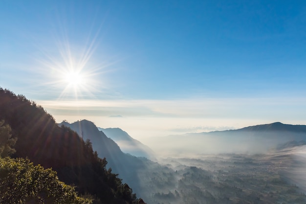 Mountain valley was covered by morning mist after sunrise