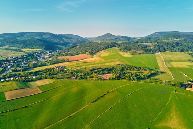 Mountain village and agricultural fields aerial view nature landscape