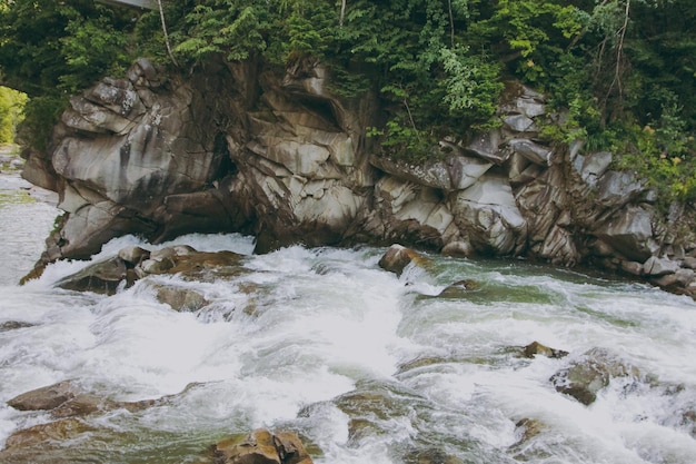 The mountain water flows over the rocks