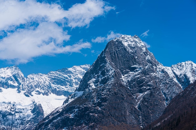 a mountain with a blue sky and a cloud in the background