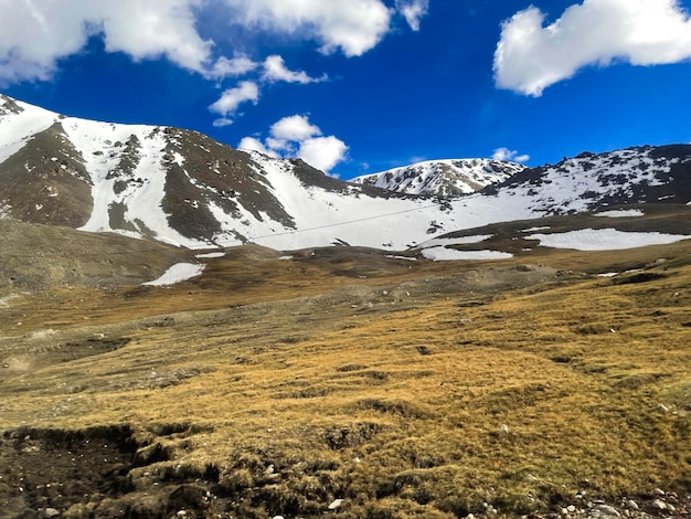 a mountain with a blue sky and a few clouds