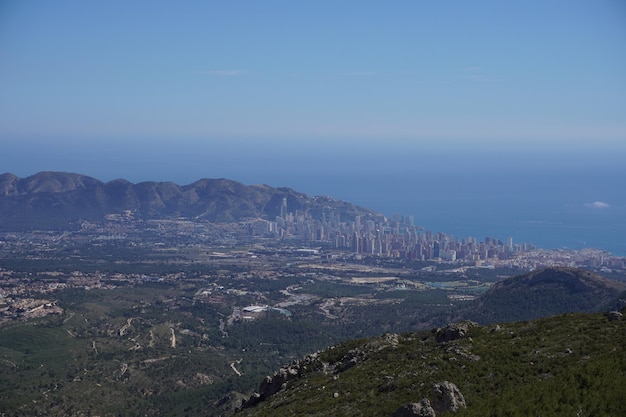 A mountain with a city in the background