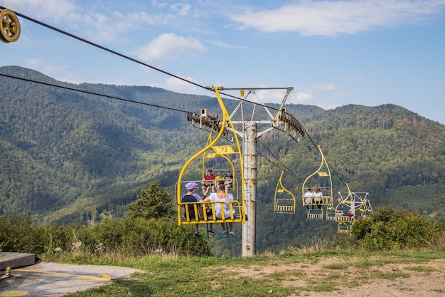 Mountain yellow lift on a summer day over the mountains Old yellow ski lift in the mountains