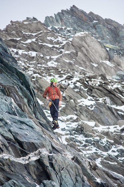 Mountaineer climbing rocky mountain in Austria