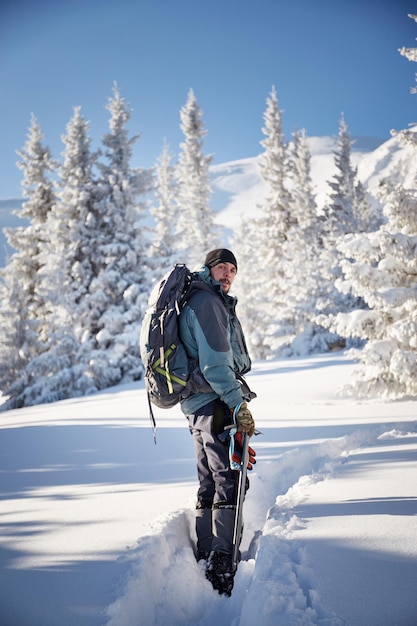 Mountaineer man in winter mountains Hiking in Carpathian mountains Ukraine Hoverla