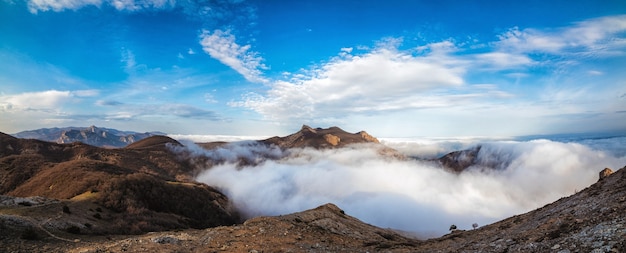 Mountains in autumn in the fog during the day, panorama