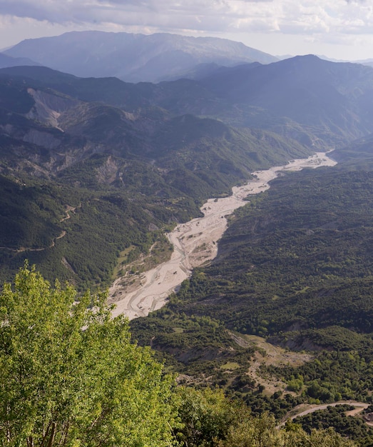 The mountains and the river Kalarrytikos Greeceon a sunny summer day