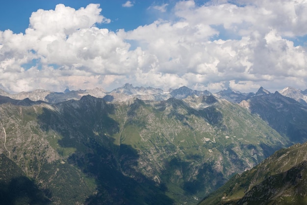 Mountains scene with dramatic cloudy sky in national park of Dombay, Caucasus, Russia. Summer landscape and sunny day