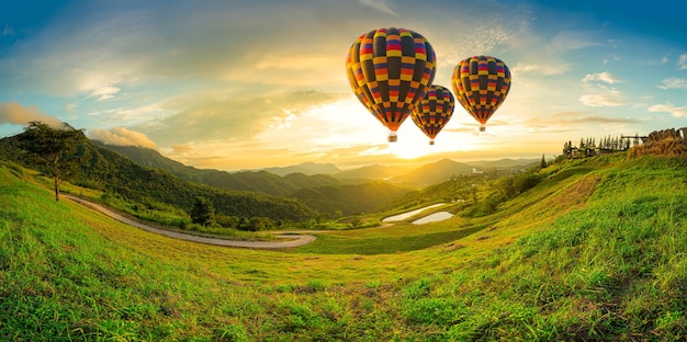 Mountains and sky with balloonsColorful hot air balloons flying over mountain at Dot Inthanon