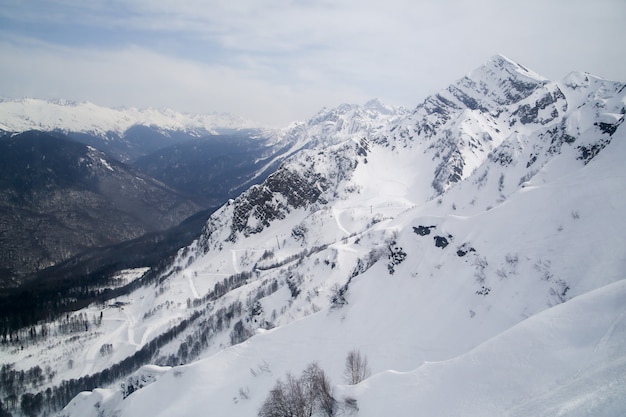 Mountains in the snow against the sky in the clouds