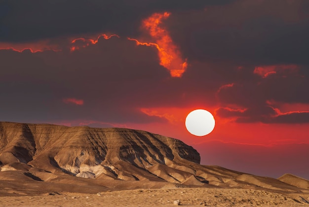 The mountains of Sodom located on the southwest side of the Dead Sea Sunset on a foggy mountain range Sodom Evening red sunset sky over mountain Sodom Gomorrah in Dead sea from Negev desert Israel