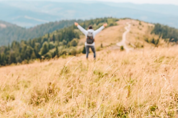 Mountains travel concept autumn season yellow grass person on background