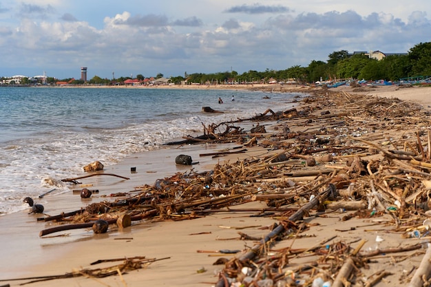 Mountains of waste and garbage on the sandy beach after the tide Humanity is polluting the ocean