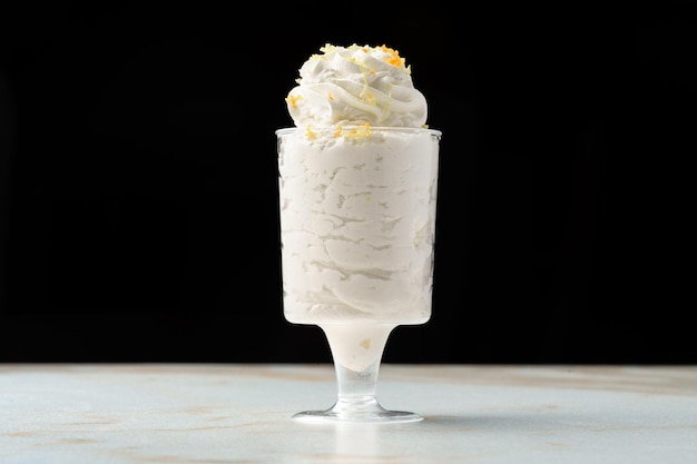 Mousse dessert with cream in glass on the table