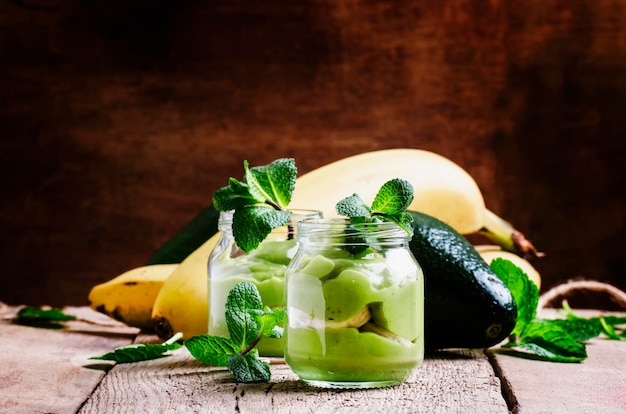 Mousse from avocado and banana with mint healthy diet food old wooden background selective focus