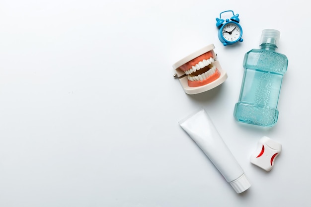 Mouthwash and other oral hygiene products on colored table top view with copy space Flat lay Dental hygiene Oral care kit Dentist concept