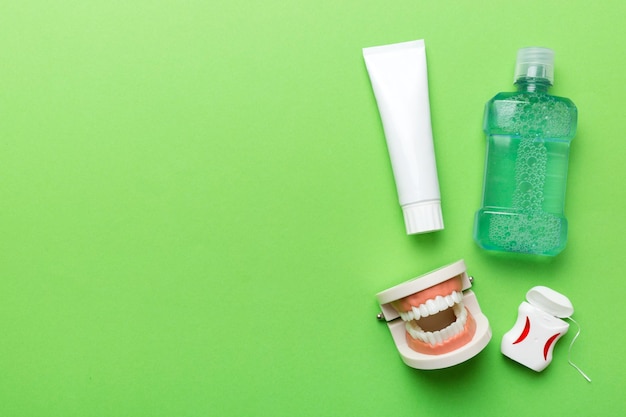 Mouthwash and other oral hygiene products on colored table top view with copy space Flat lay Dental hygiene Oral care kit Dentist concept