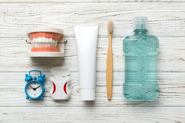 Mouthwash and other oral hygiene products on colored table top view with copy space Flat lay Dental hygiene Oral care kit Dentist concept