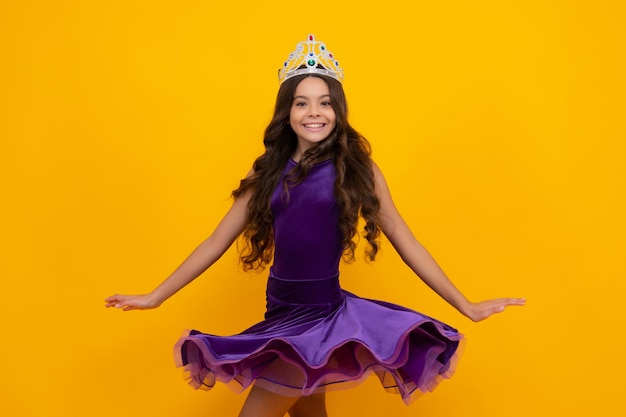 Movement windy dress Child princess crown on isolated studio background Happy girl face positive and smiling emotions