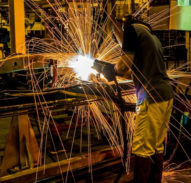 The movement of workers with protective mask welding metal.