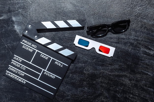 Movie clapper board and 3d glasses on chalk blackboard. Cinema industry, entertainment