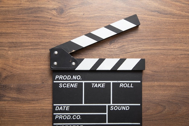 Movie clapper on the wooden background