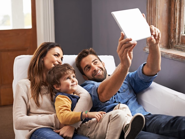 Movie time in the modern age Shot of a happy family using a digital tablet together