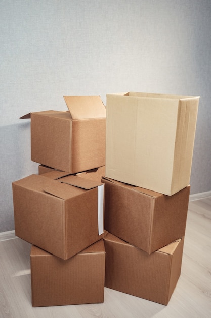 Moving in. Stack of cardboard boxes in the empty room.