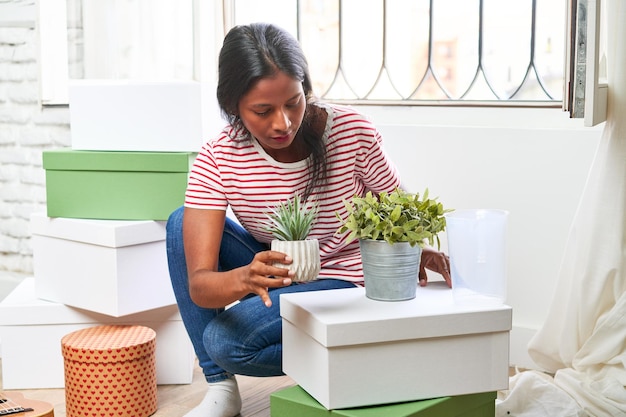 Moving in Young Indian woman unpacking in new home