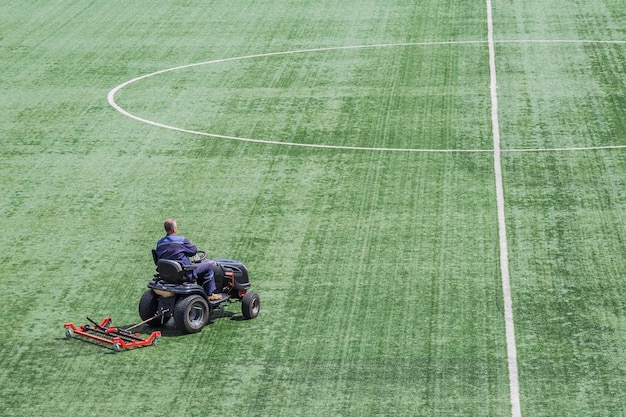 Mowing grass in a football stadium