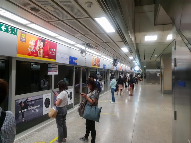 MRT subway train with entrance door and a clock